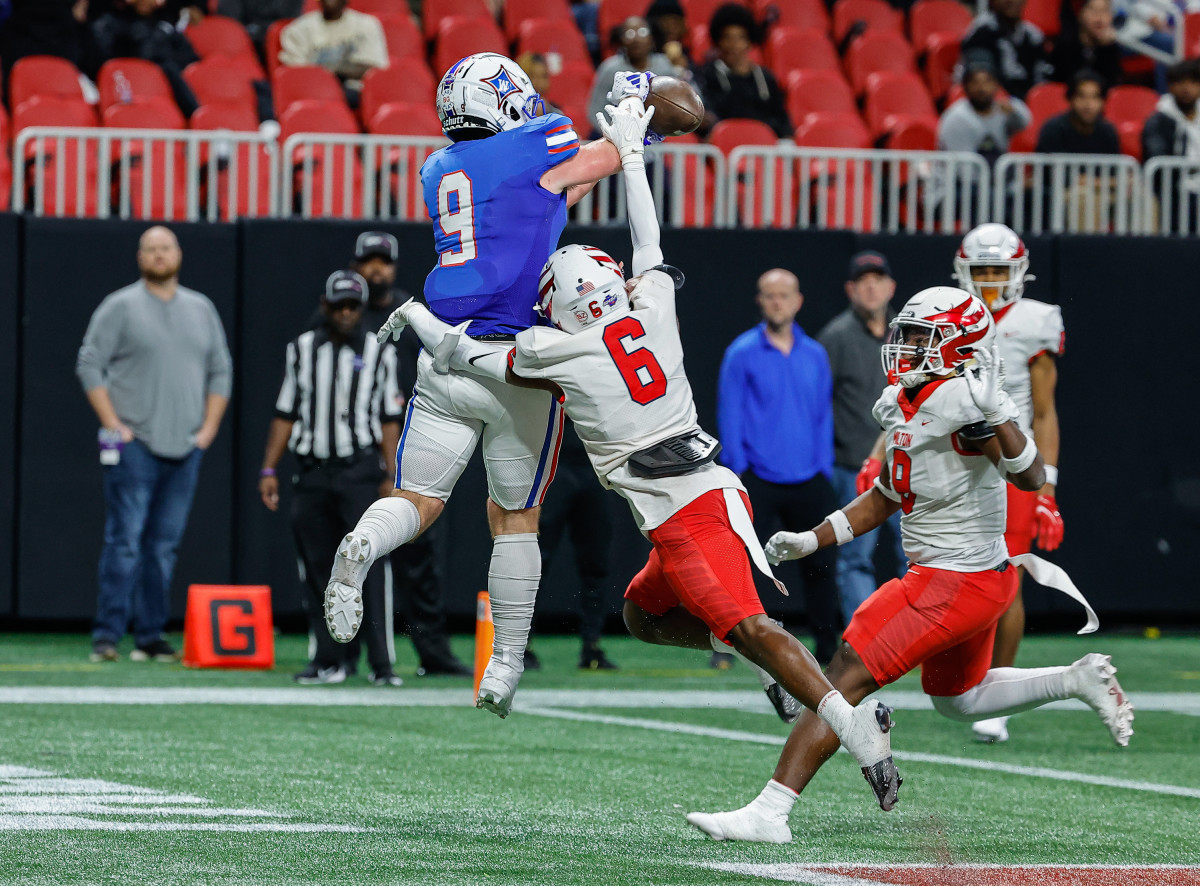 Milton's Faisal Sokoya breaks up a pass intended for Walton's Hunter Teal. The Eagles secondary had a dominant performance, which included three interceptions.